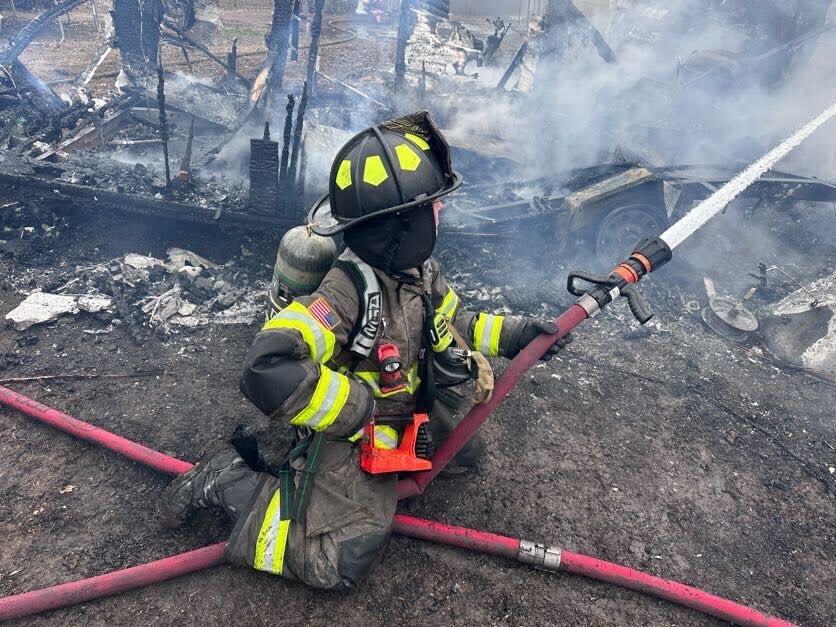FF Mathenia working a hose line at a structure fire